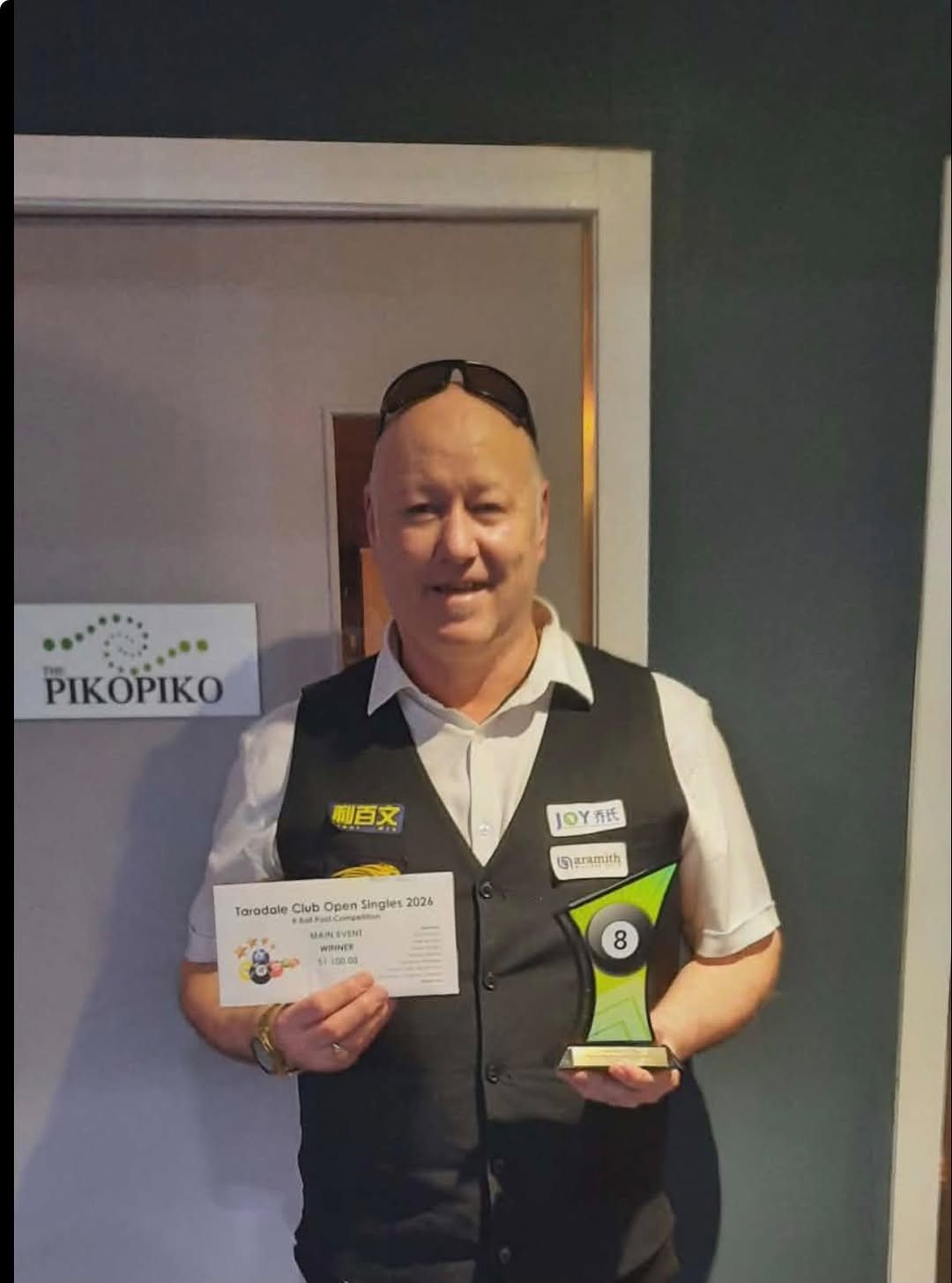 Pool player holding the Taradale Club Open Singles 2026 main event winner trophy
